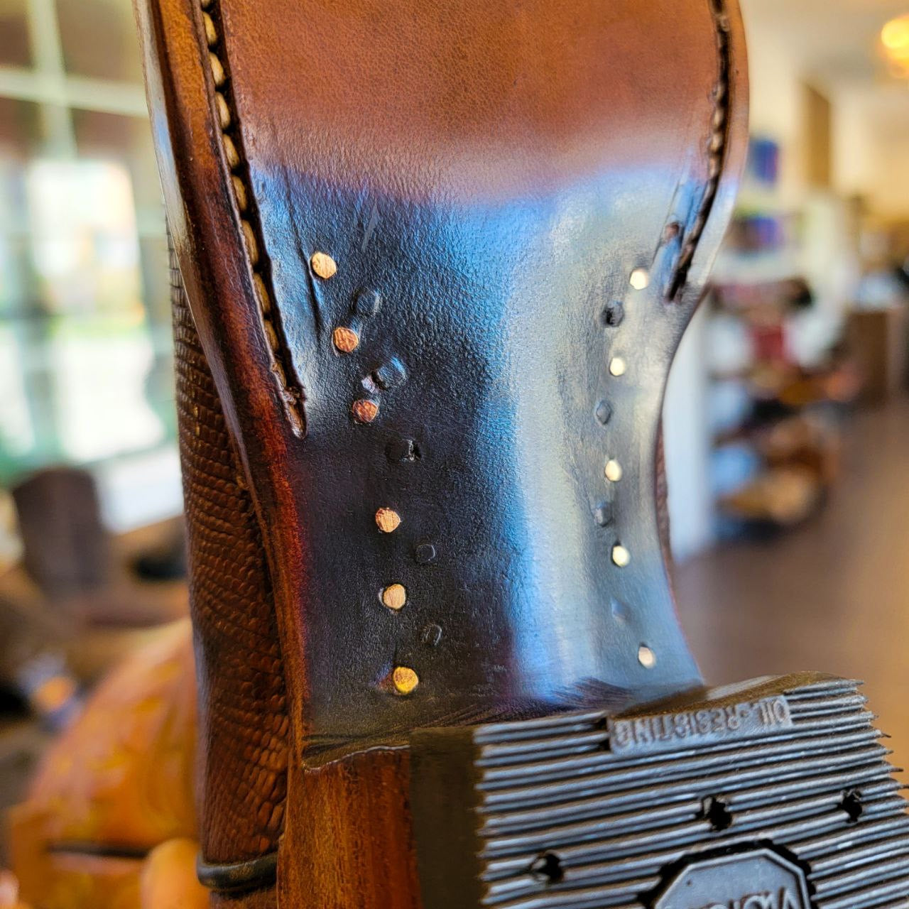 A vintage pair of HYER Lizard skin Cowboy Boots size 8B for sale after being repaired with new leather soles and rubber heels at the cowboy boot repair center
