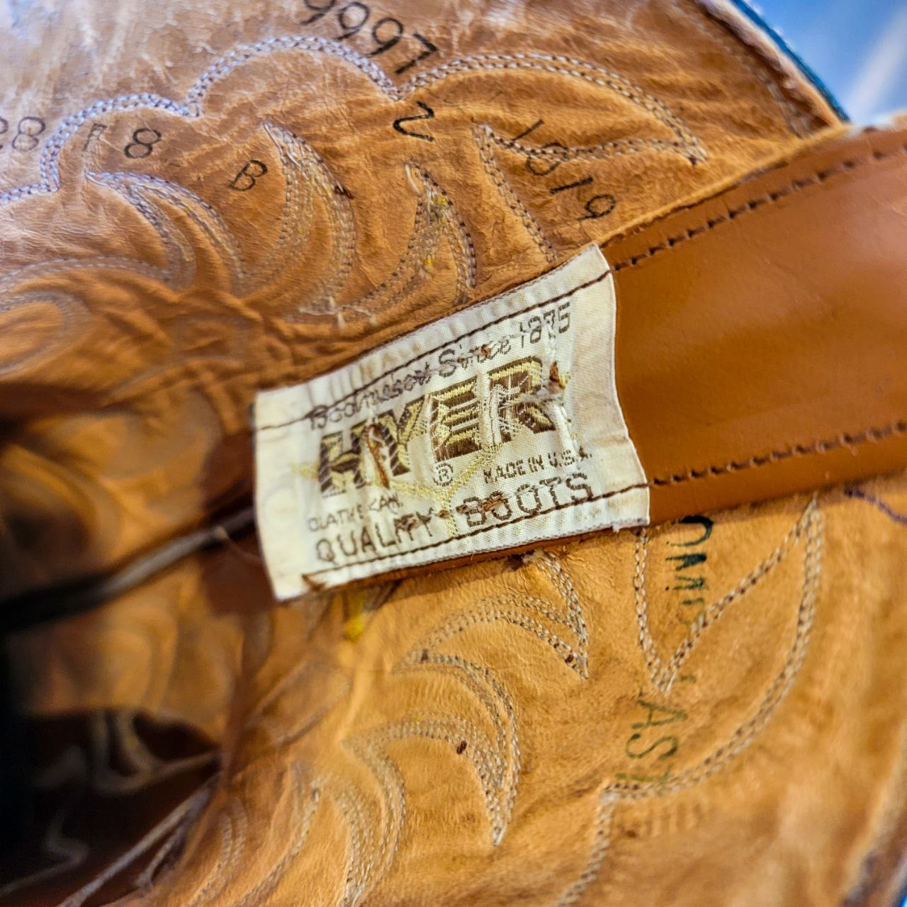 A vintage pair of HYER Lizard skin Cowboy Boots size 8B for sale after being repaired with new leather soles and rubber heels at the cowboy boot repair center