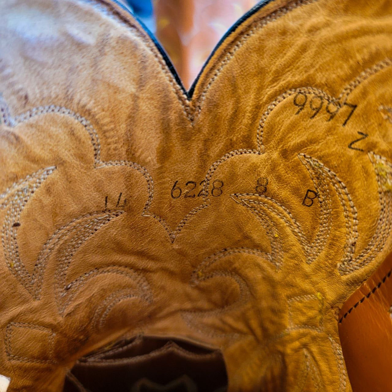 A vintage pair of HYER Lizard skin Cowboy Boots size 8B for sale after being repaired with new leather soles and rubber heels at the cowboy boot repair center