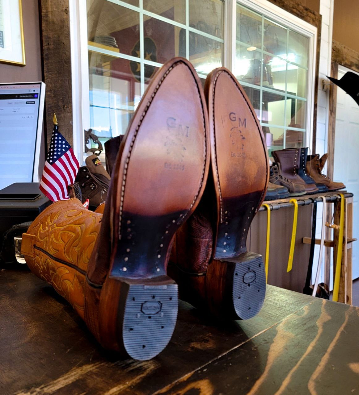 A vintage pair of HYER Lizard skin Cowboy Boots size 8B for sale after being repaired with new leather soles and rubber heels at the cowboy boot repair center