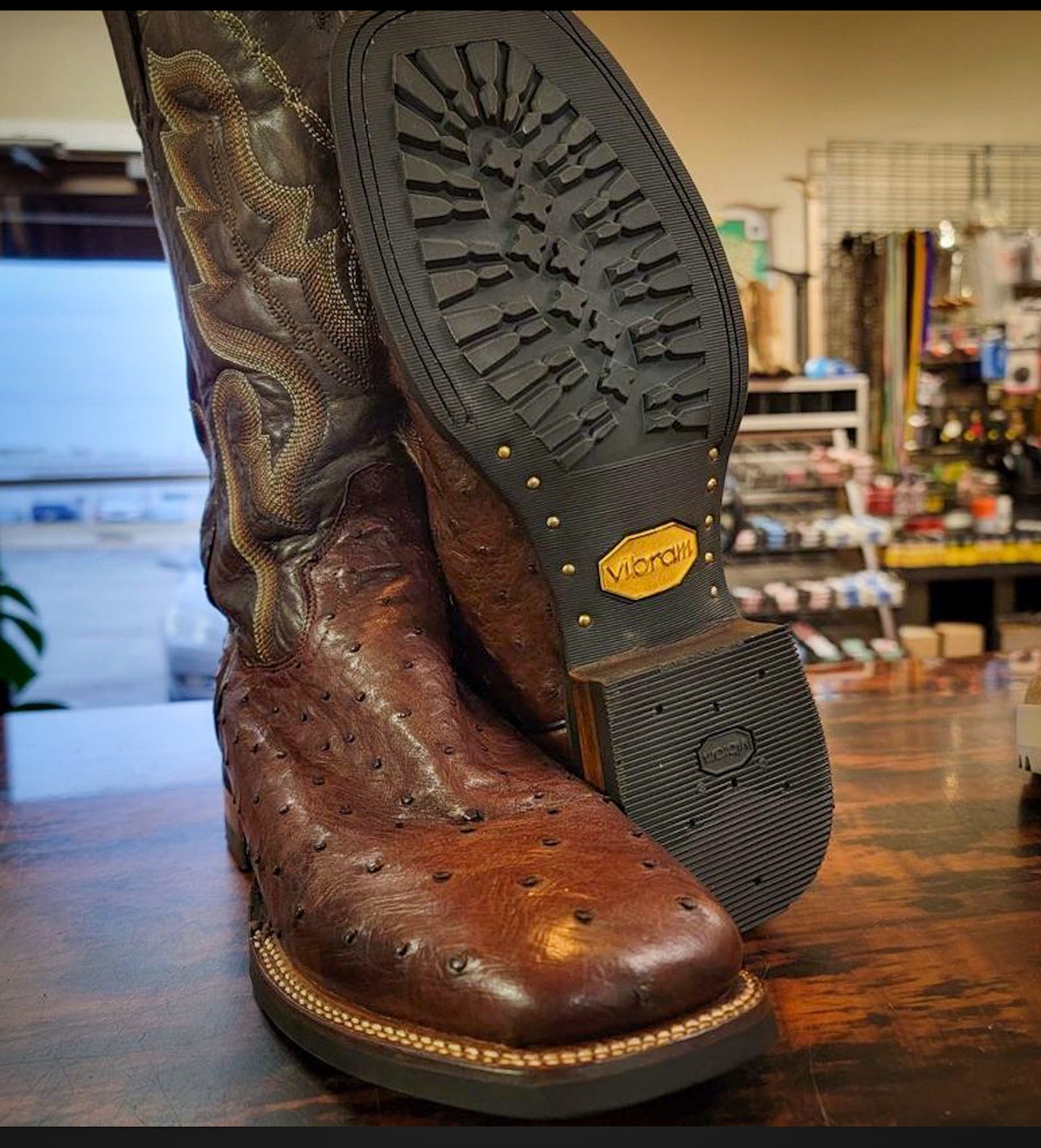 A pair of brown Dan Post Ostrich Skin Cowboy Boots Repaired with new Vibram 430 soles in black