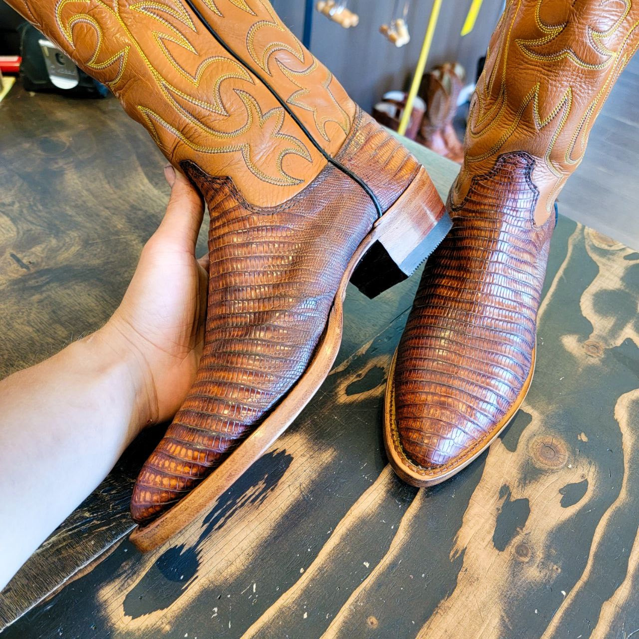 A vintage pair of HYER Lizard skin Cowboy Boots size 8B for sale after being repaired with new leather soles and rubber heels at the cowboy boot repair center