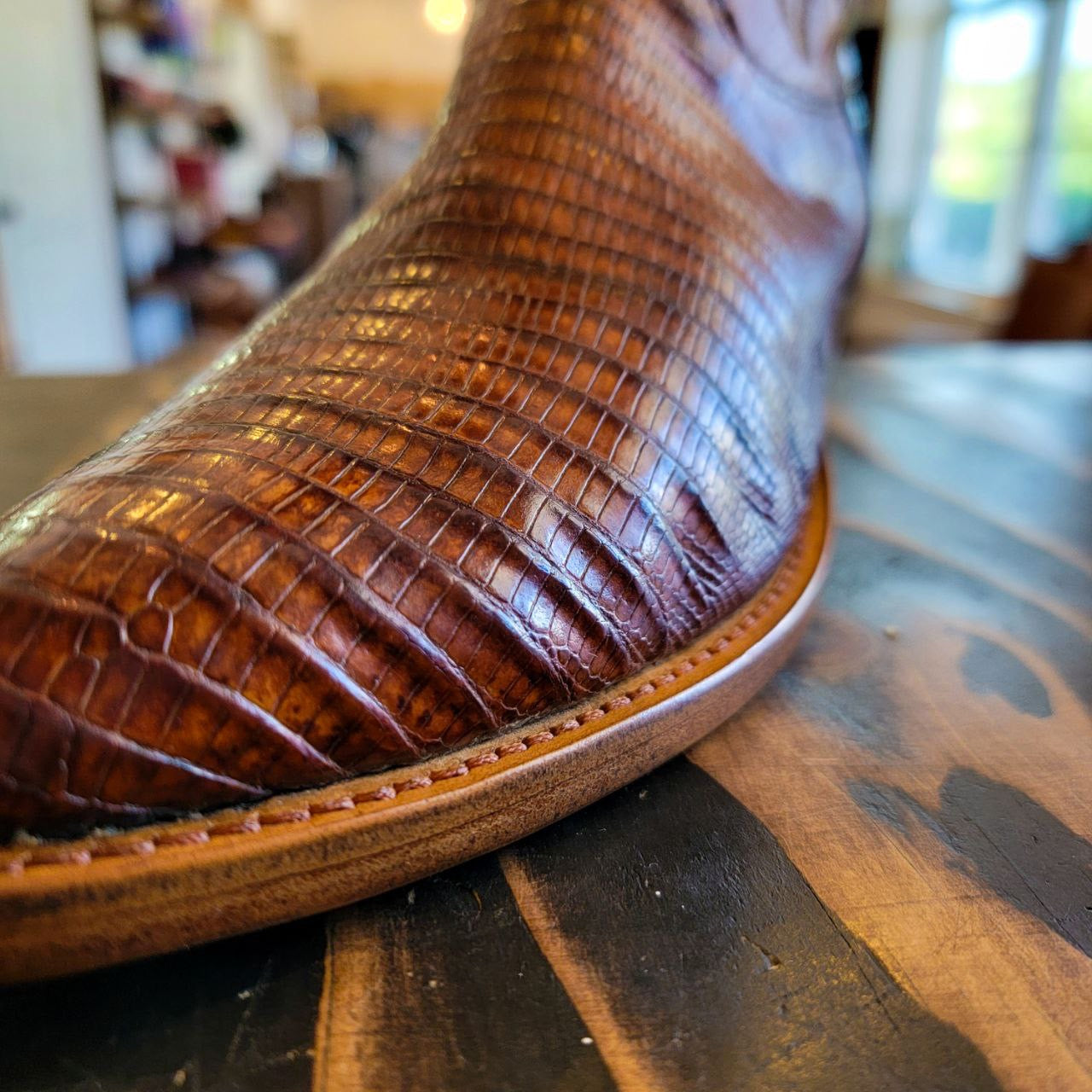 A vintage pair of HYER Lizard skin Cowboy Boots size 8B for sale after being repaired with new leather soles and rubber heels at the cowboy boot repair center