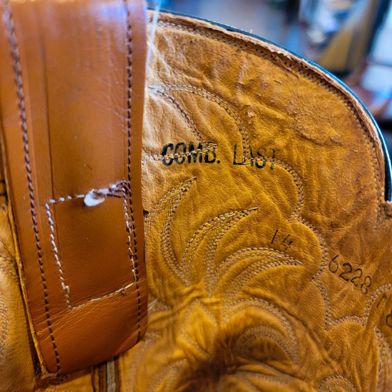 A vintage pair of HYER Lizard skin Cowboy Boots size 8B for sale after being repaired with new leather soles and rubber heels at the cowboy boot repair center