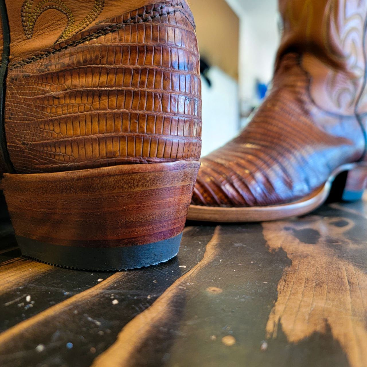 A vintage pair of HYER Lizard skin Cowboy Boots size 8B for sale after being repaired with new leather soles and rubber heels at the cowboy boot repair center