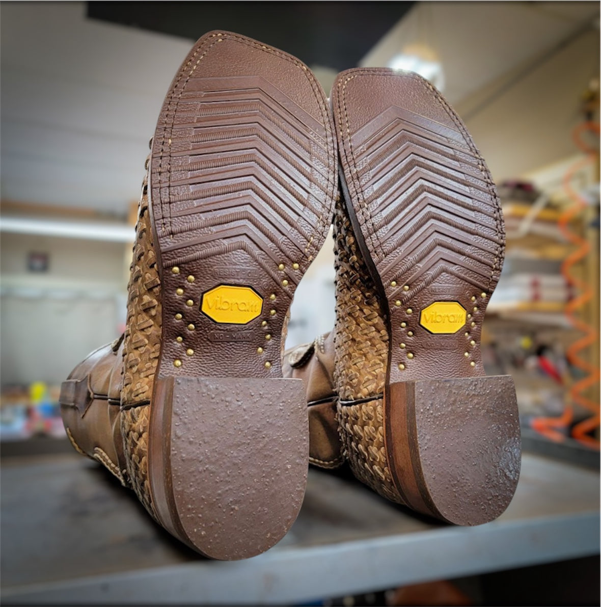 A pair of Dan Post Basket Weave Cowboy Boots Resoled With New Brown Vibram 700 Tygum Soles