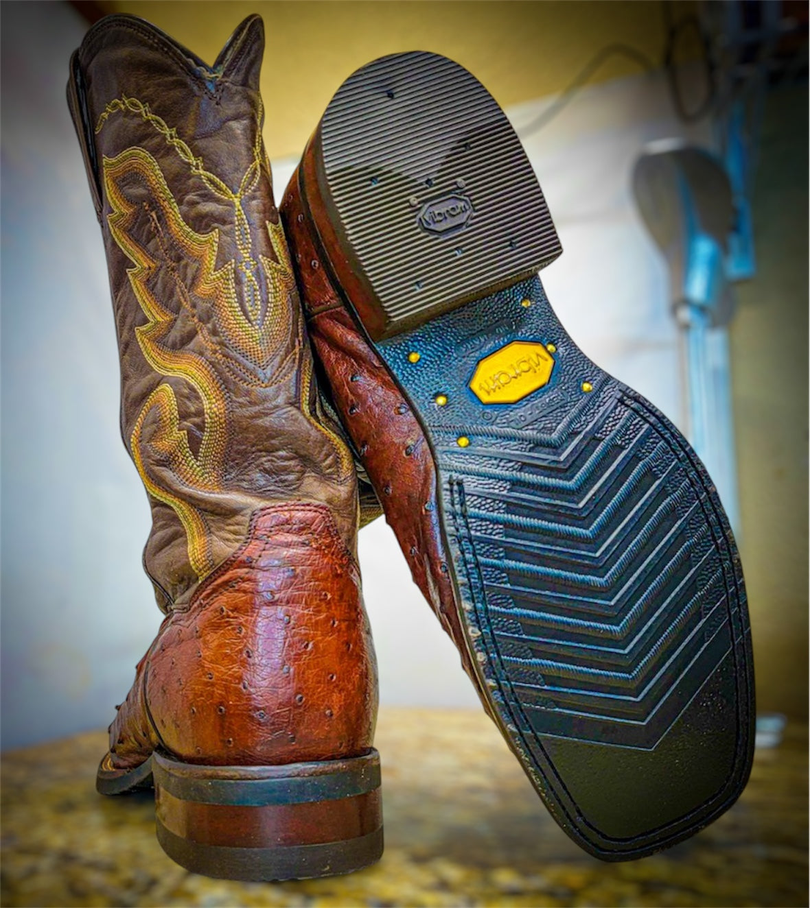 A pair of Dan Post Ostrich Skin Cowboy Boots Resoled with new black Vibram 700 Tygum soles
