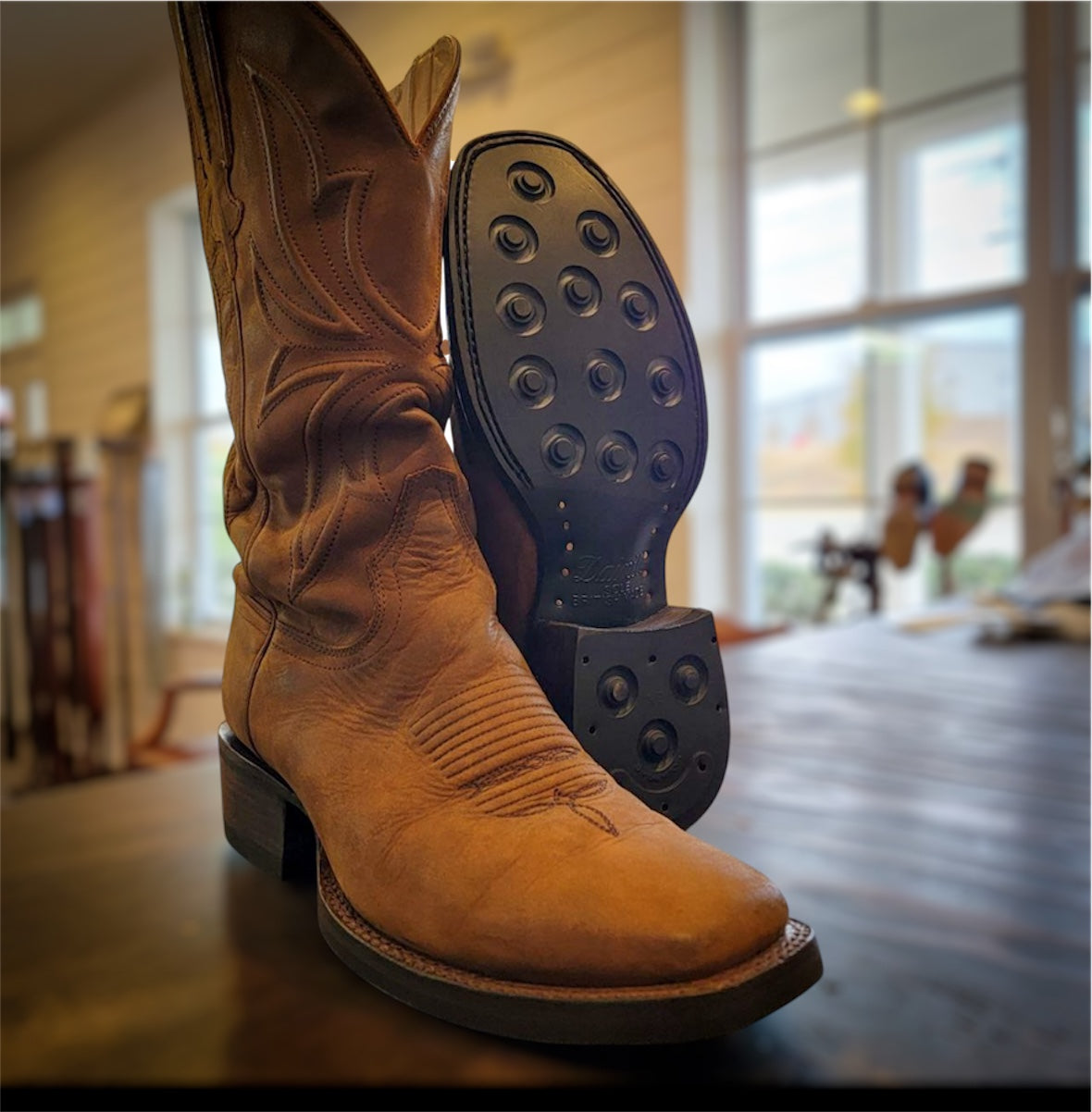 A pair of Thursday Cowboy Boots resoled with new Dainite soles and heels