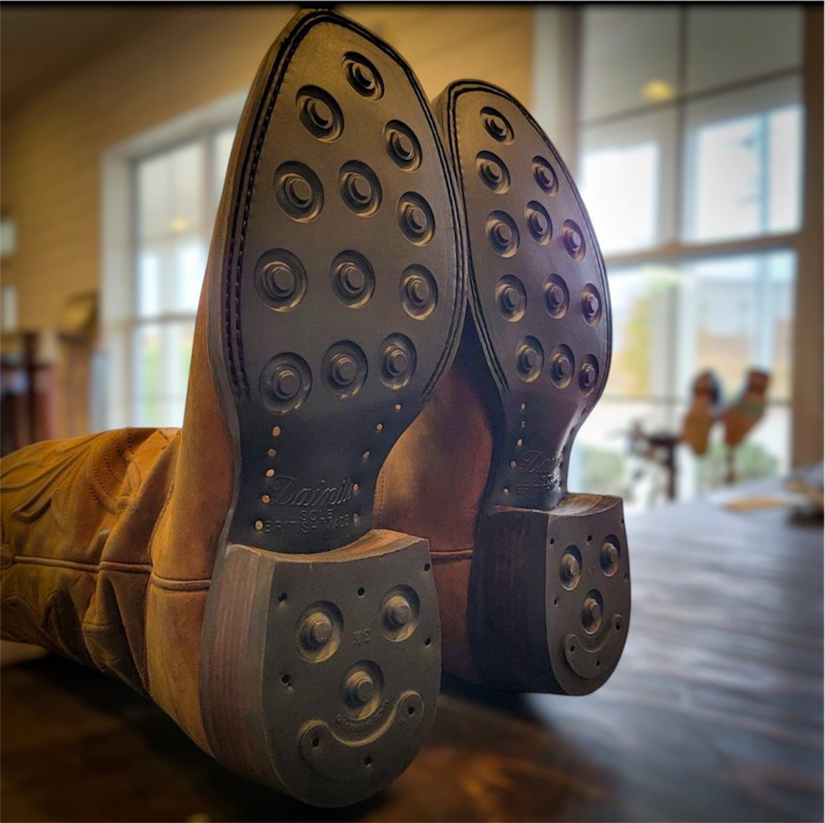 A pair of Thursday Cowboy Boots resoled with new Dainite soles and heels