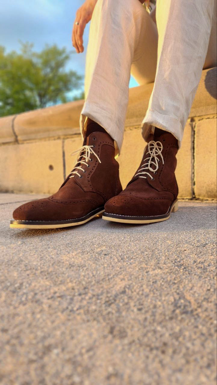 A Pair of Chocolate Brown Suede Wingtips made by Thursday Boot Company and customized with a cream colored Dr Sole Full Soles and Heels. 