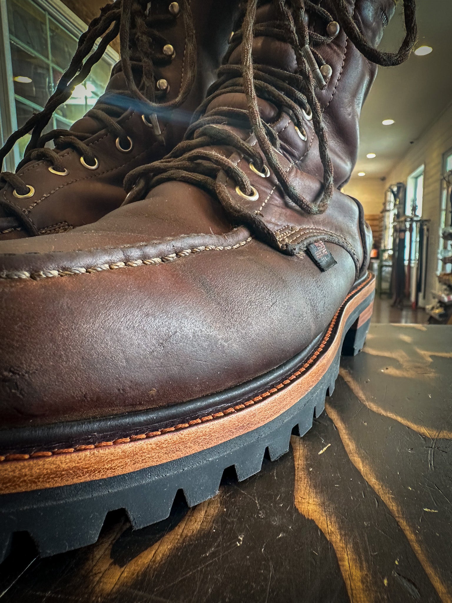 a pair of Thorogood work boots after being repaired with new Vibram 100 Soles and Heels at the boot repair center