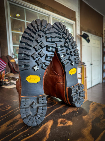 A pair of Redwing Iron Ranger Boots after being repaired with new Vibram 100 soles and heels at the Redwing Boot repair center