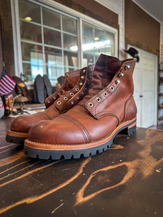 A pair of Redwing Iron Ranger Boots after being repaired with new Vibram 100 soles and heels at the Redwing Boot repair center