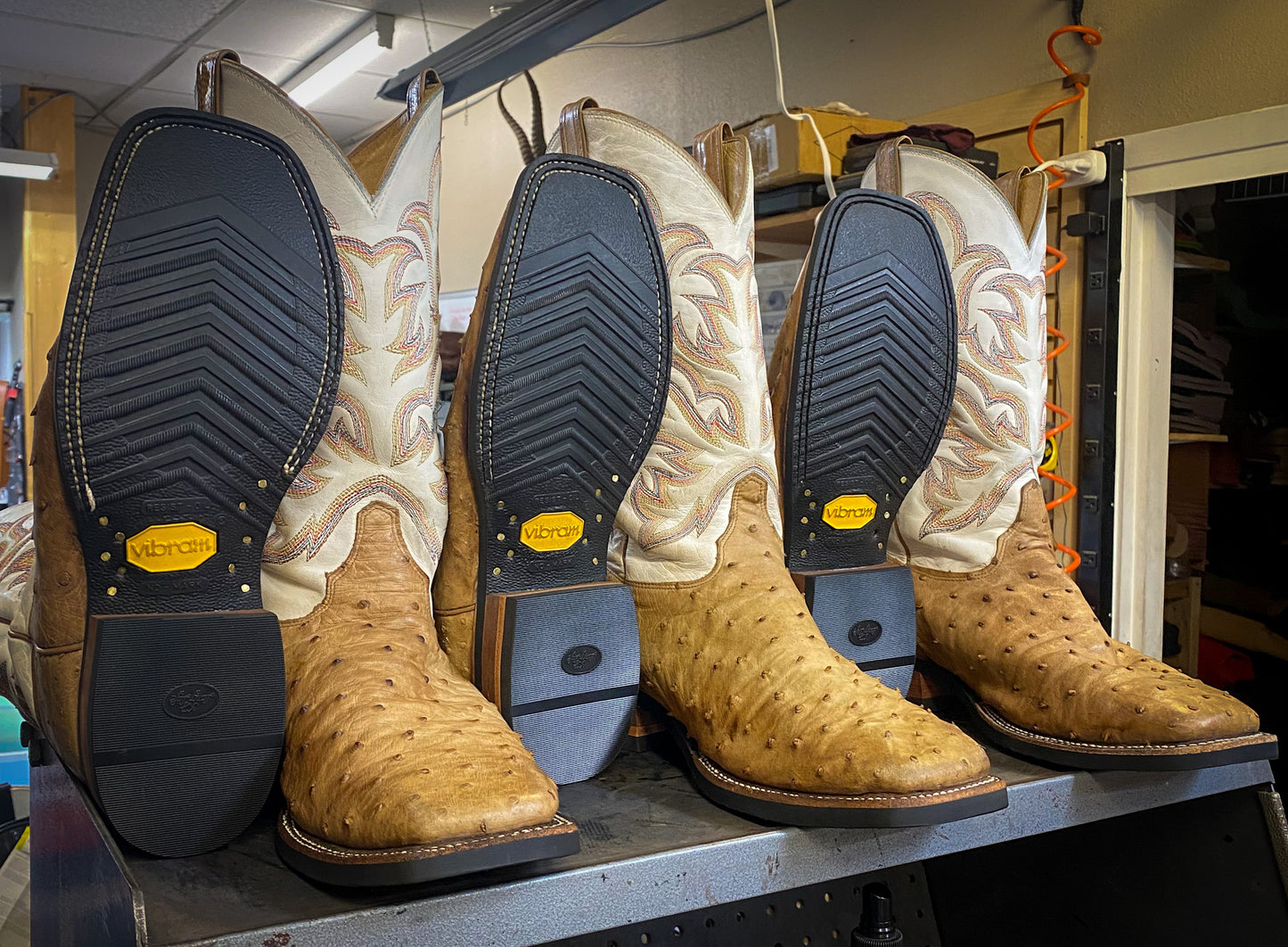 3 pairs of ostrich skin cowboy boots repaired with new Vibram 700 soles and heels at the Cowboy Boot Repair Center