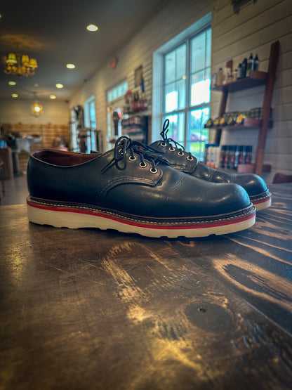 A pair of redwing shoes after being repaired with new Vibram wedge soles and a red midsole at the Redwing Boot Repair Center