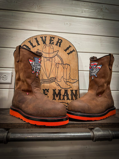 a pair of Redwing pull-on work boots after being repaired with new Red Vibram wedge soles at the Redwing Boot repair center