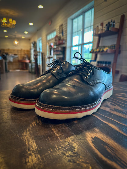 A pair of redwing shoes after being repaired with new Vibram wedge soles and a red midsole at the Redwing Boot Repair Center