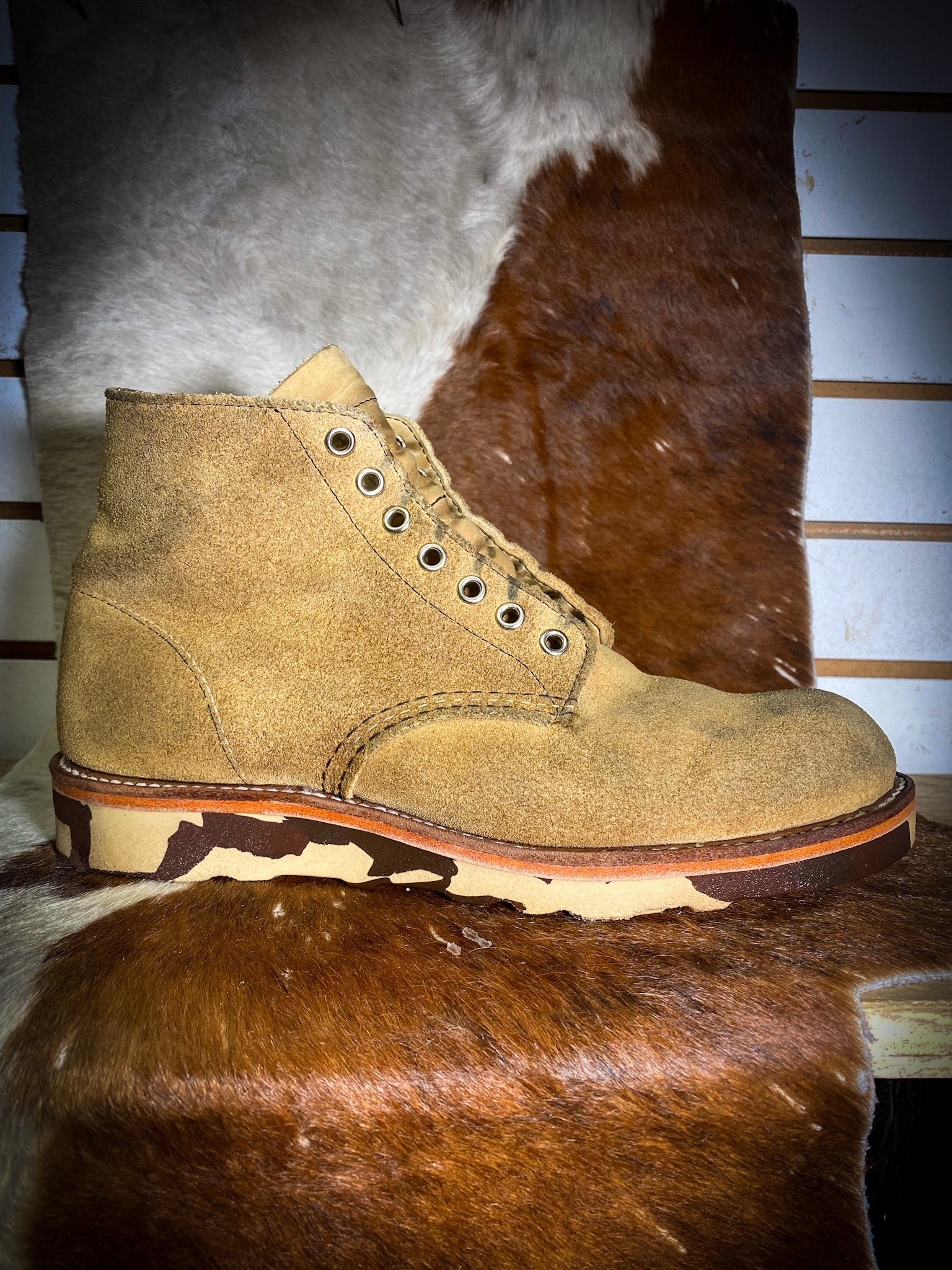 a pair of Redwing Suede Boots after being repaired with new Vibram Camo Wedge Soles at the Redwing Boot Repair Center