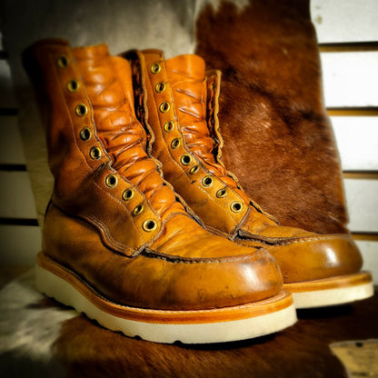 A pair of work boots after being repaired with new Vibram wedge soles at the boot repair center