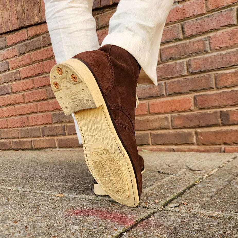 A Pair of Chocolate Brown Suede Wingtips made by Thursday Boot Company and customized with a cream colored Dr Sole Full Soles and Heels. 