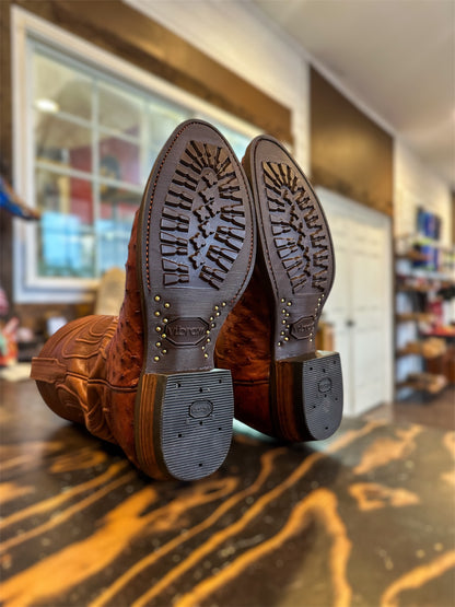 A pair of Tecovas Ostrich Skin Cowboy Boots Repaired with new Vibram 430 soles in brown