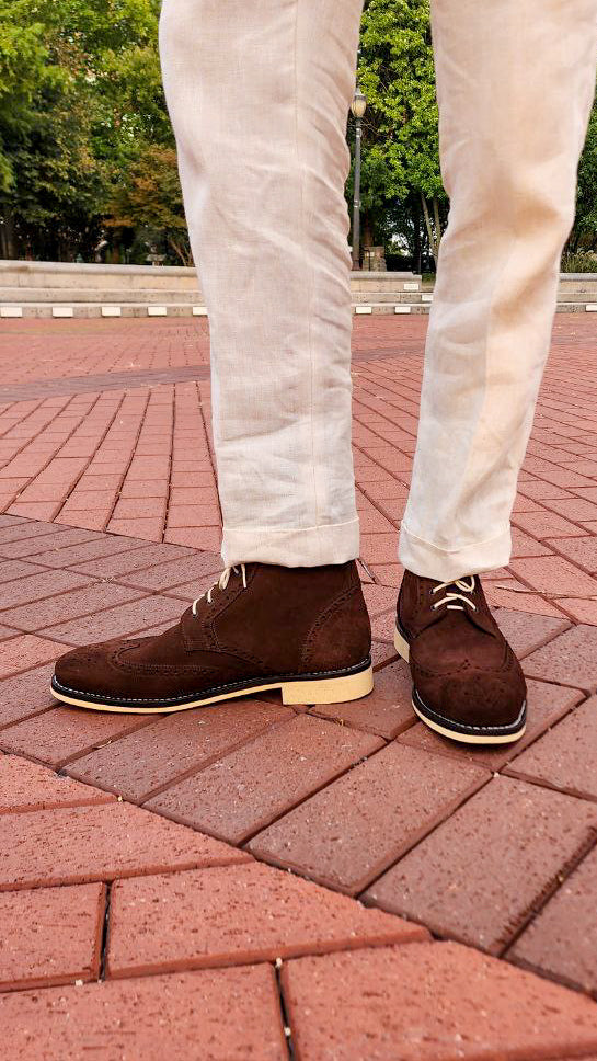 A Pair of Chocolate Brown Suede Wingtips made by Thursday Boot Company and customized with a cream colored Dr Sole Full Soles and Heels. 