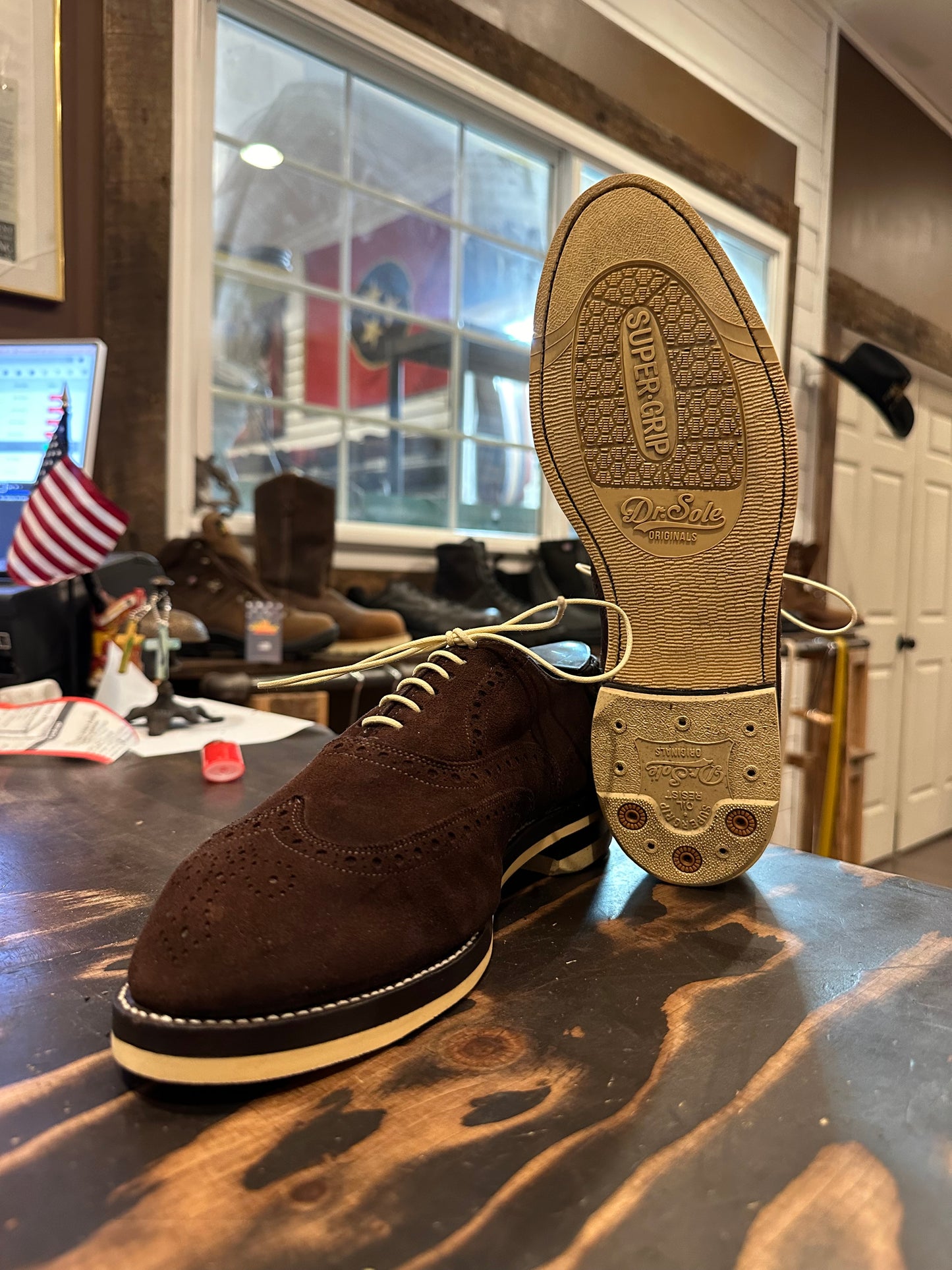 A pair of brown suede wingtip Allen Edmonds dress shoes repaired with Dr Sole cream Full Soles and Heels at the dress shoe repair center