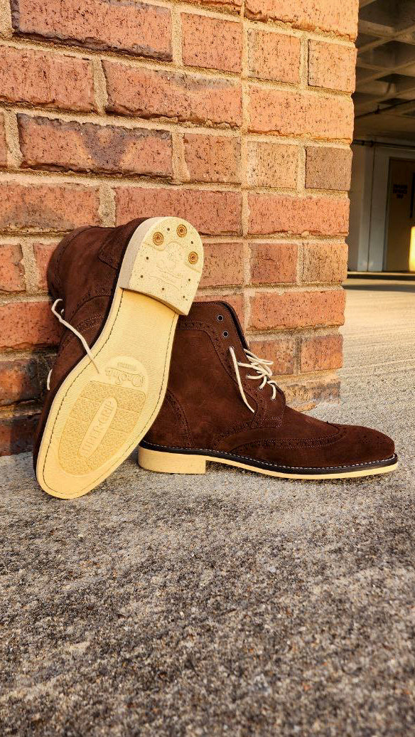 A Pair of Chocolate Brown Suede Wingtips made by Thursday Boot Company and customized with a cream colored Dr Sole Full Soles and Heels. 