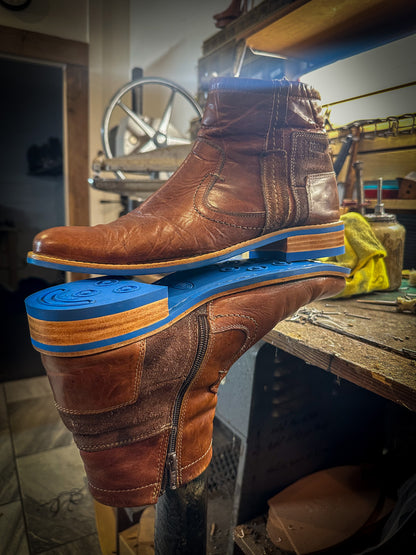 A pair of dress boots repaired with new Blue Andes Rubber Soles and Heels at the Boot repair center