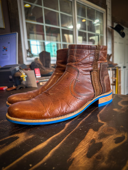 A pair of dress boots repaired with new Blue Andes Rubber Soles and Heels at the Boot repair center