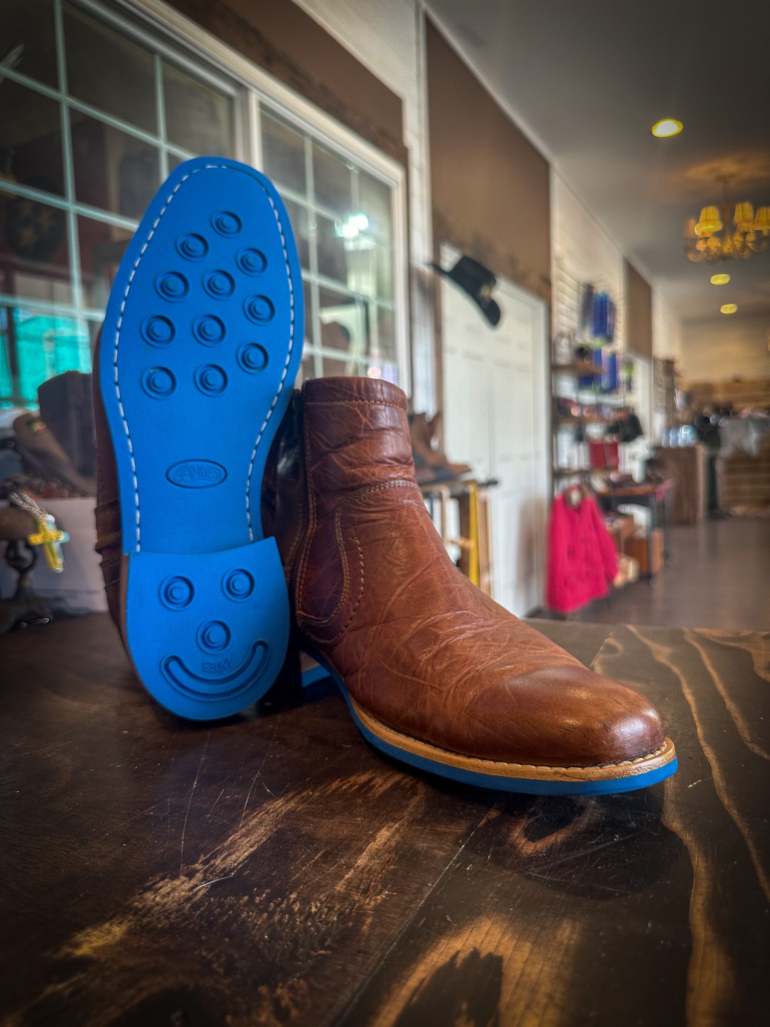 A pair of dress boots repaired with new Blue Andes Rubber Soles and Heels at the Boot repair center