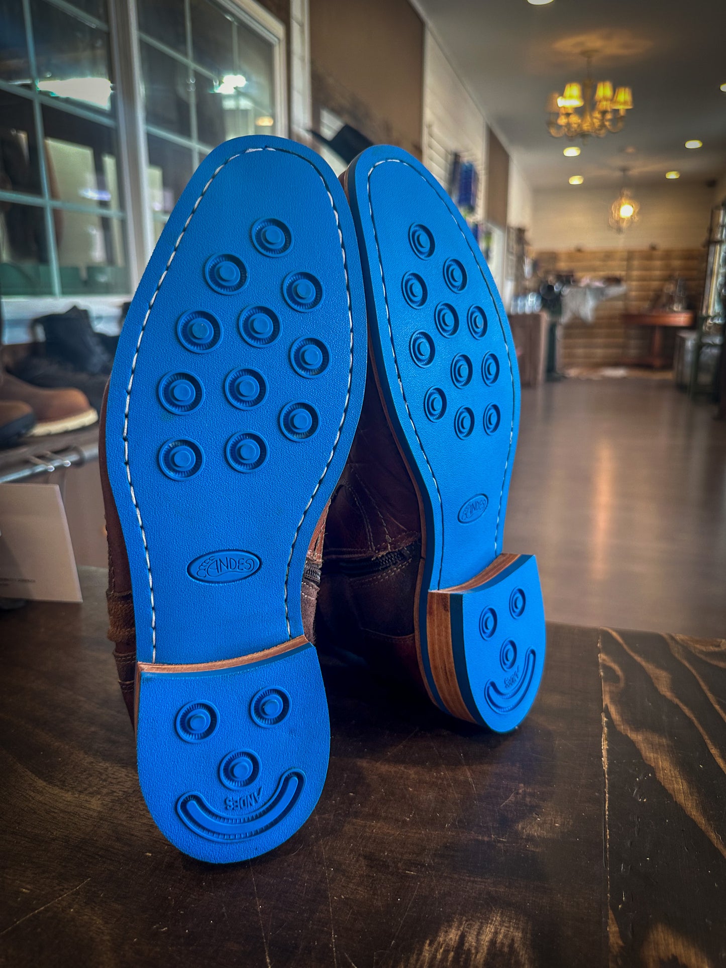 A pair of dress boots repaired with new Blue Andes Rubber Soles and Heels at the Boot repair center