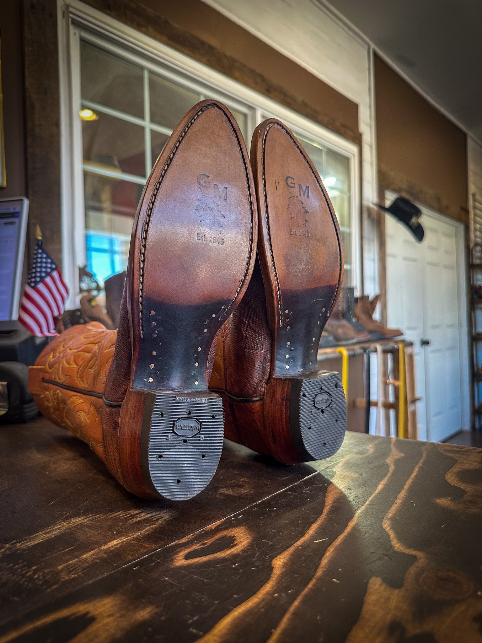 a pair of vintage HYER Lizard skin cowboy boots after being repaired with new leather soles and the cowboy boot repair center