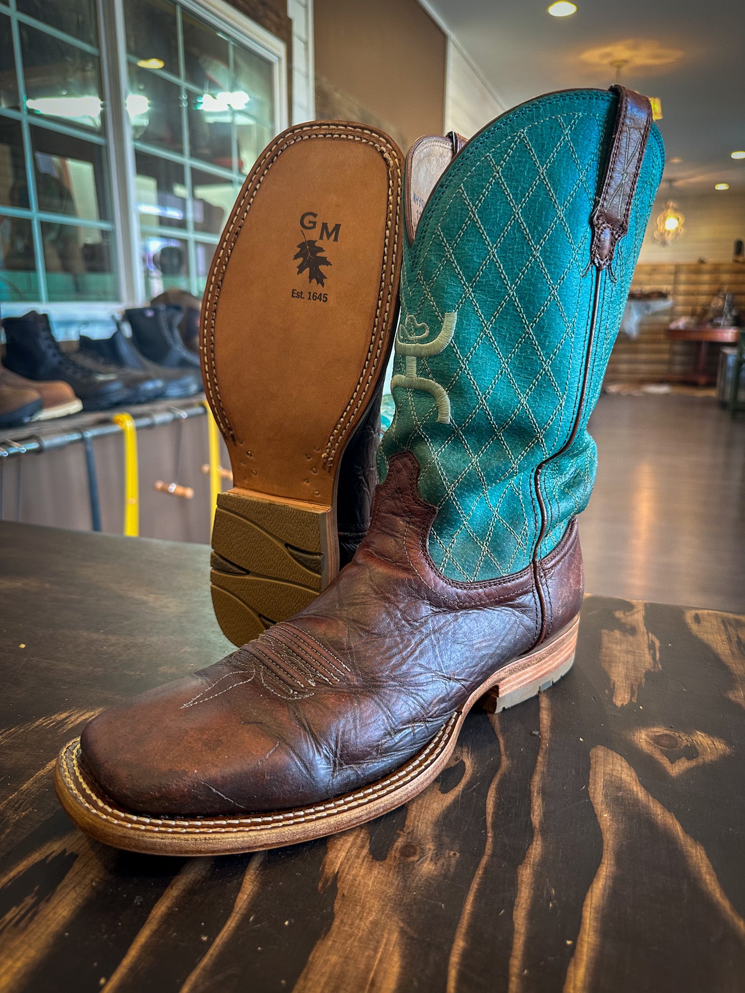 a pair of square toe cowboy boots after being repaired with new leather soles at the cowboy boot repair center