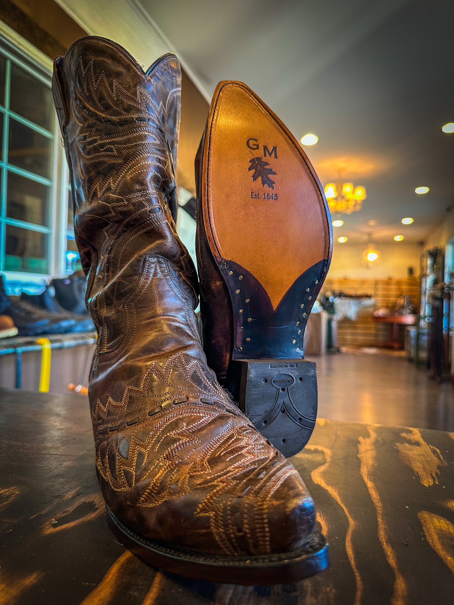 a pair of cowboy boots repaired with new leather soles at the cowboy boot repair center