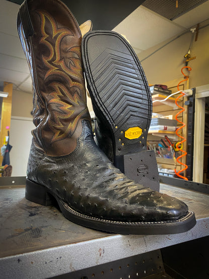 A pair of Square Toe Dan Post Ostrich Skin Cowboy Boots after being repaired with new Vibram 700 Soles and heels at The Cowboy Boot Repair Center