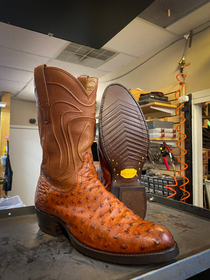 A pair of Tecovas Ostrich Skin Cowboy Boots after being repaired with new Vibram 700 n Tygum Soles and Heels at The Cowboy Boot Repair Center