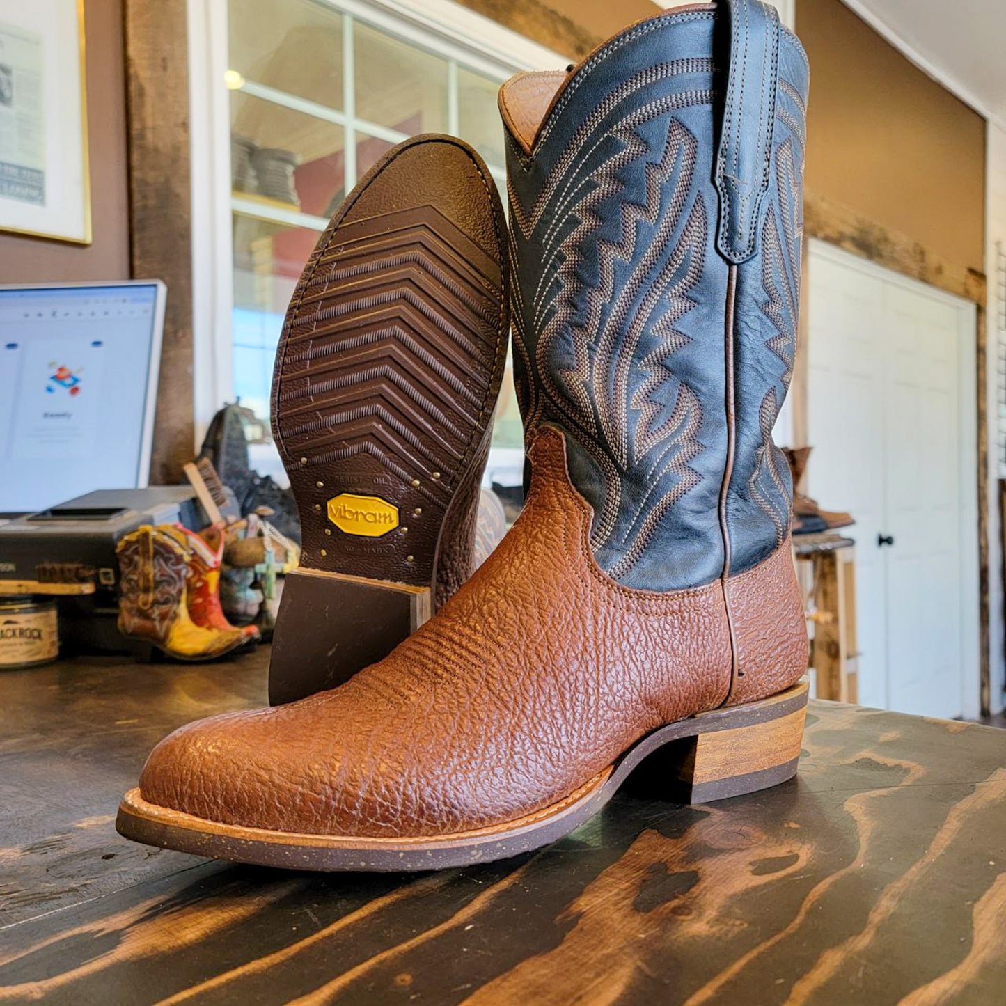 A pair of Bison Skin Tecovas Cowboy Boots after being repaired with new Vibram 700 Tygum Soles and heels at the Cowboy Boot Repair Center