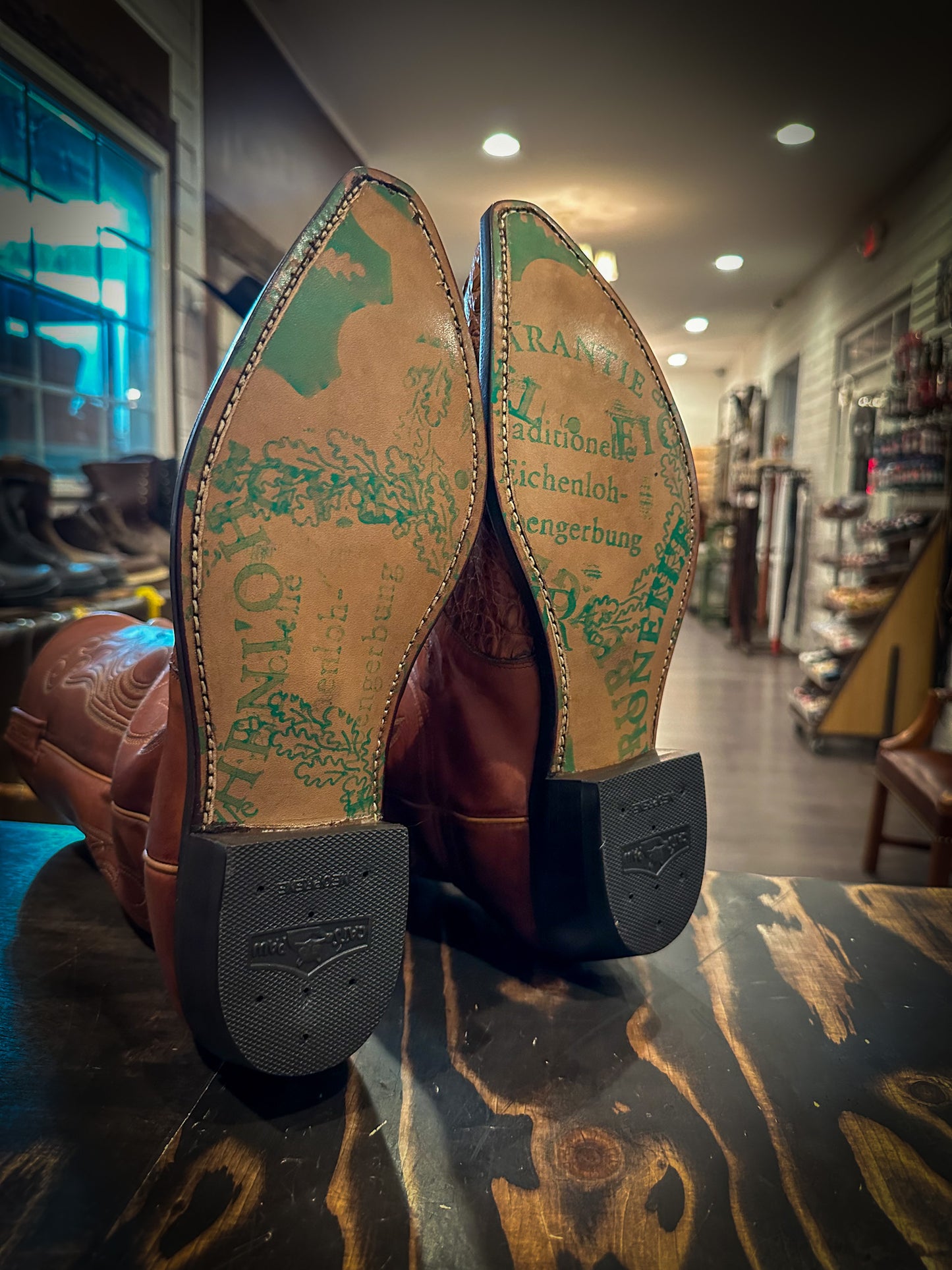 a pair of Caiman Skin Cowboy Boots after being repaired with new JR Graffiti soles and rubber heels at the cowboy boot repair center