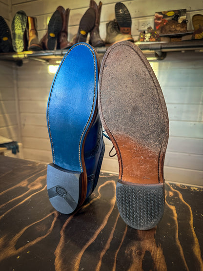 A pair of Allen Edmonds Walnut Strands Before and after being repaired with new leather soles at the dress shoe repair center