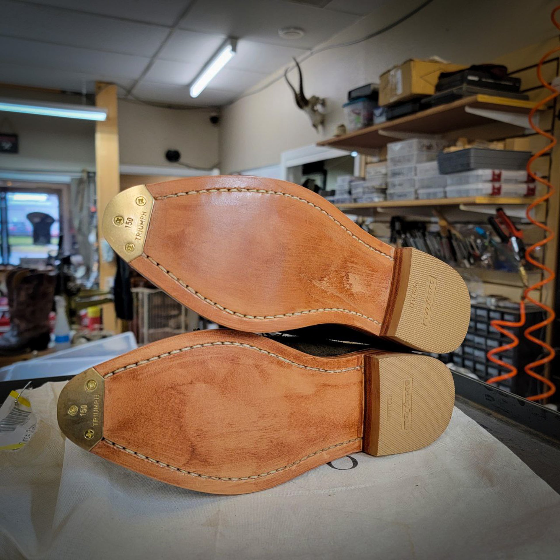 a pair of Nisolo dress shoes after being repaired with new leather soles at the dress shoe repair center