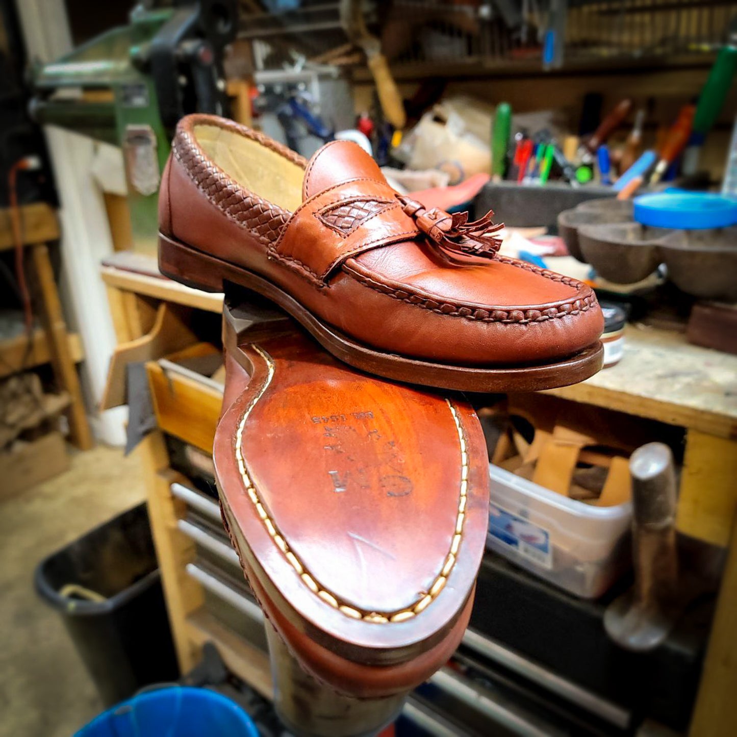 a pair of Allen Edmond Dress shoes after being repaired with new leather soles at the dress shoe repair center