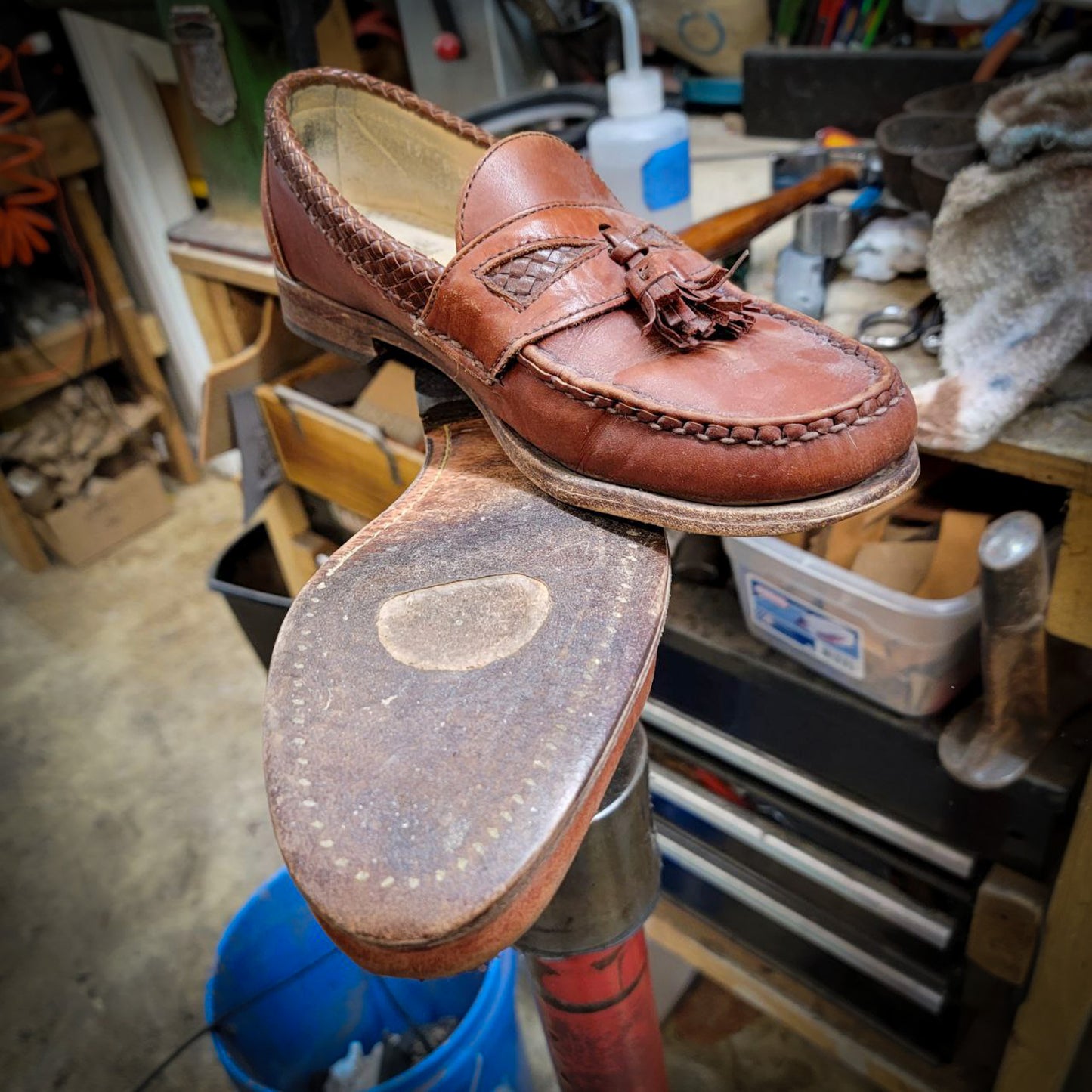 a pair of Allen Edmond Dress shoes before being repaired with new leather soles at the dress shoe repair center