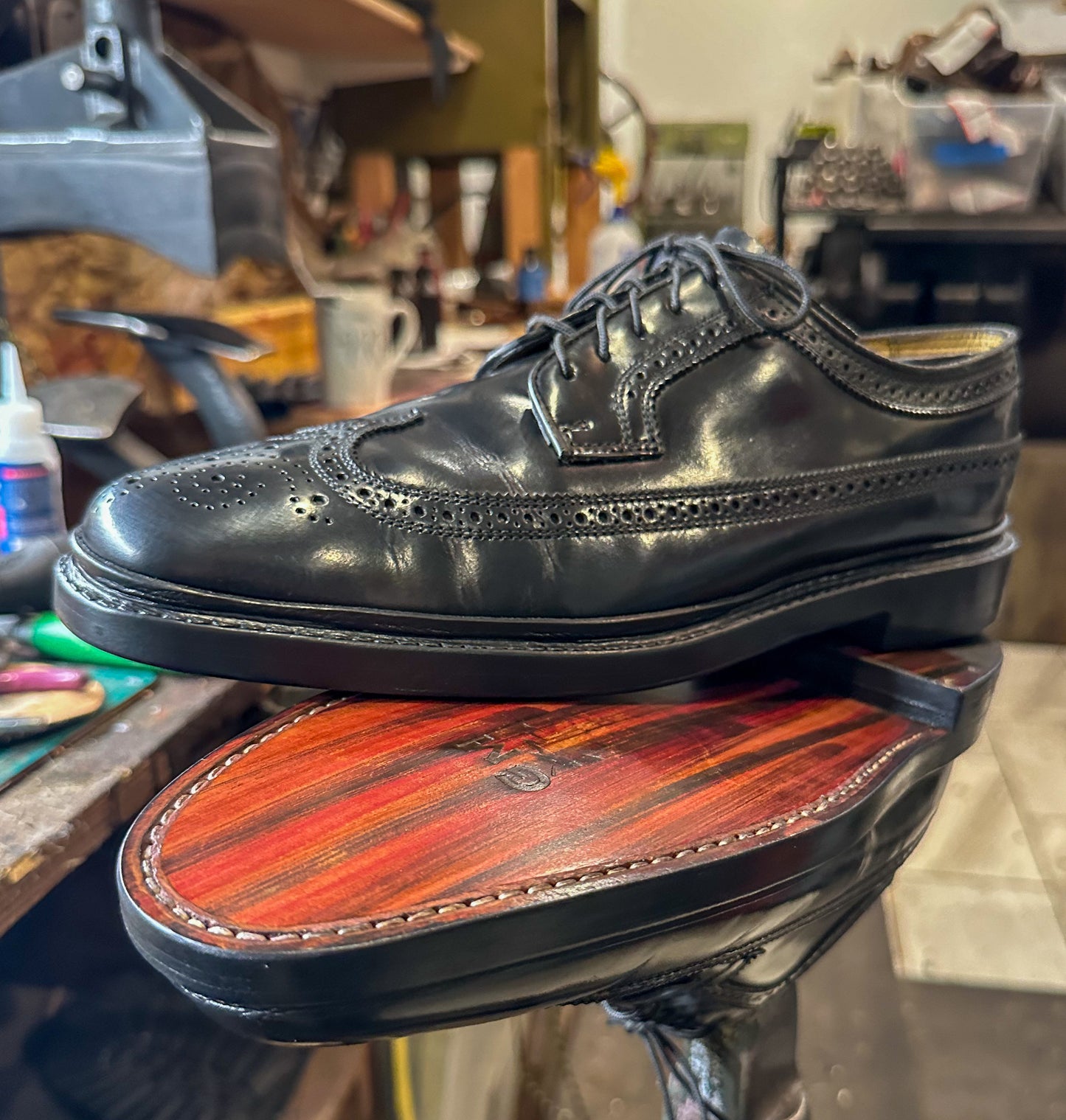 A pair of Vintage Florshiem Wingtip Dress Shoes after being repaired with new leather soles at our dress shoe repair center with our Benchmark Repair Package