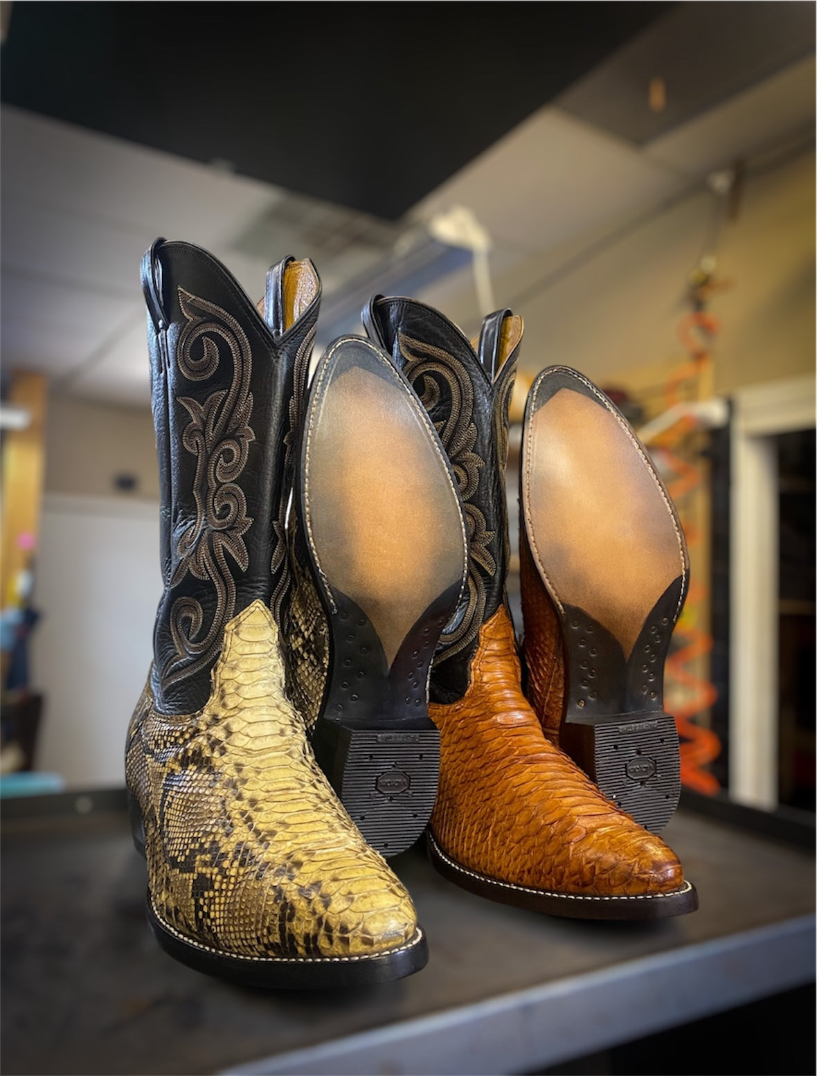 2 pairs of snake skin cowboy boots resoled with new leather soles and rubber heels