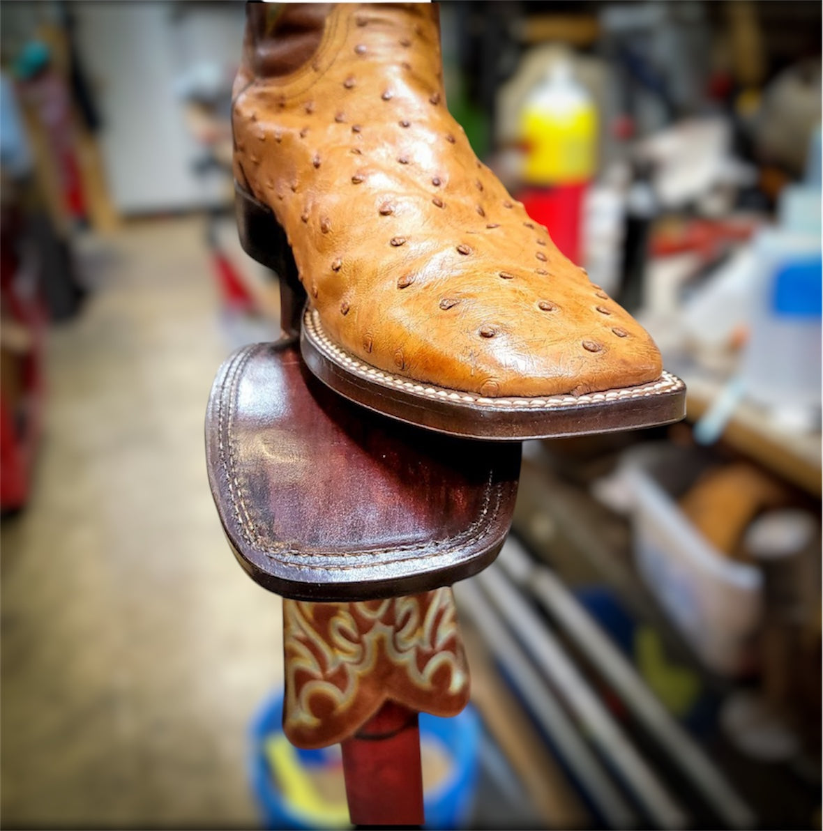 A pair of Ostrich skin cowboy boots resoled with new leather soles and rubber heels