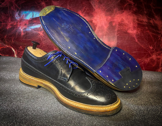 A pair of Allen Edmonds MacNeil Wingtip Dress Shoes after being customized and repaired with new JR Leather soles and Combo Heels at the dress shoe repair center