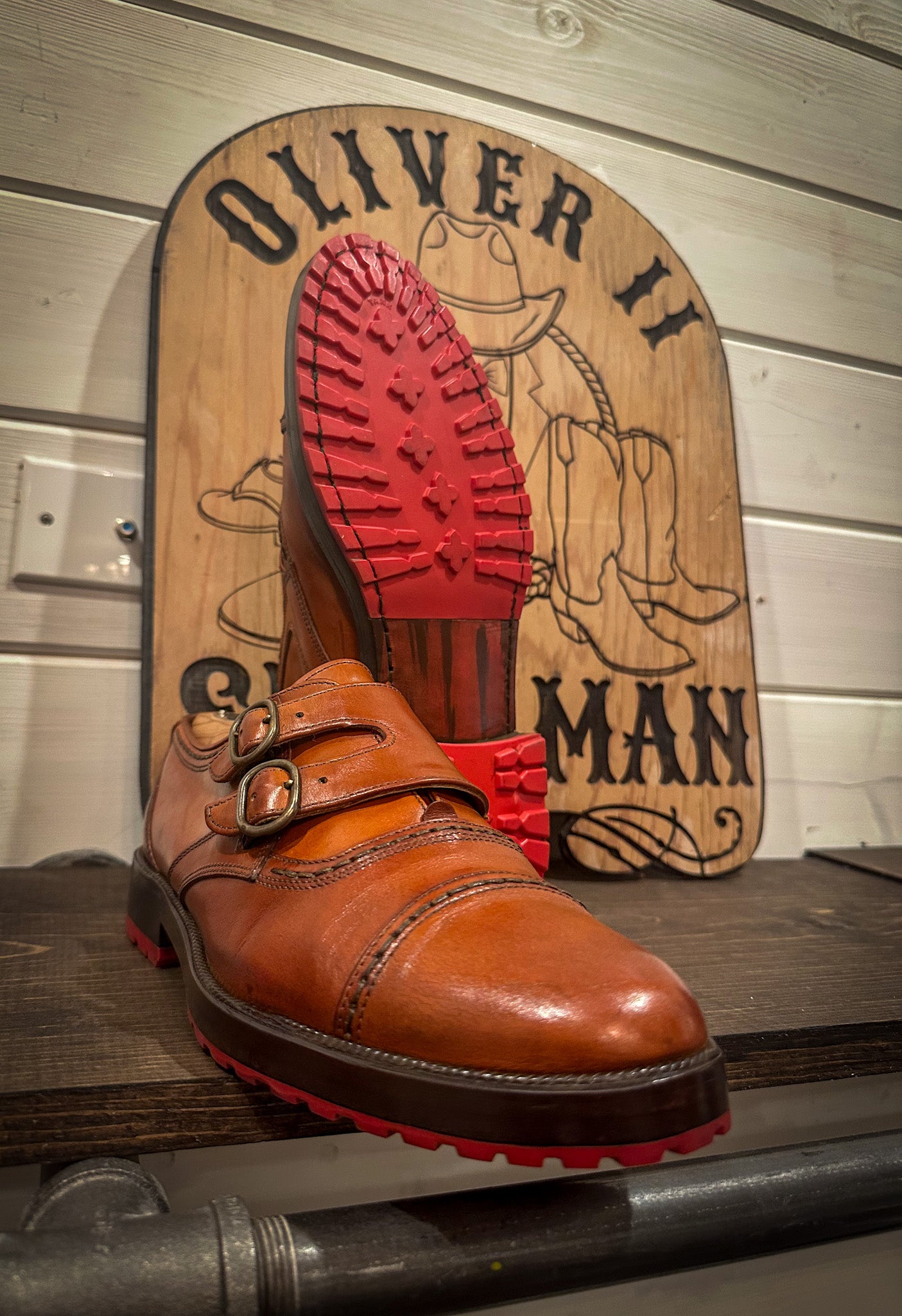 a pair of double monk strap dress shoes repaired with new red mini lug half soles and heels at the dress shoe repair center