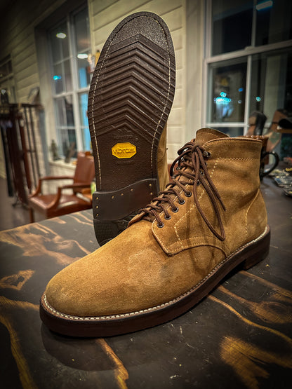 A pair of brown suede Alden Boots after being repaired with new Vibram 700 Tygum soles and heels at the boot repair center