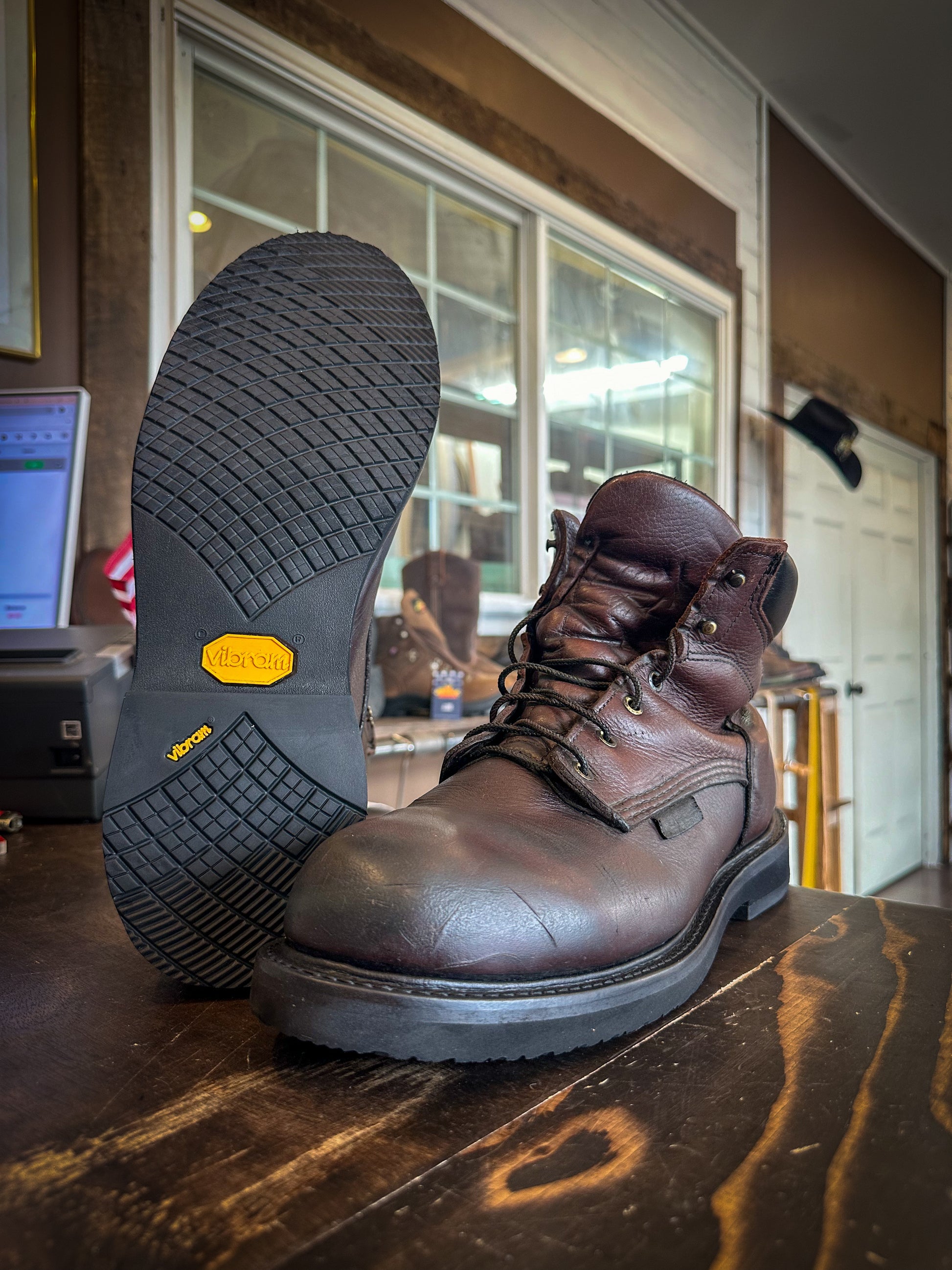 A pair of Redwing work boots after being repaired with new Vibram Long Haul Soles at the Boot Repair Center